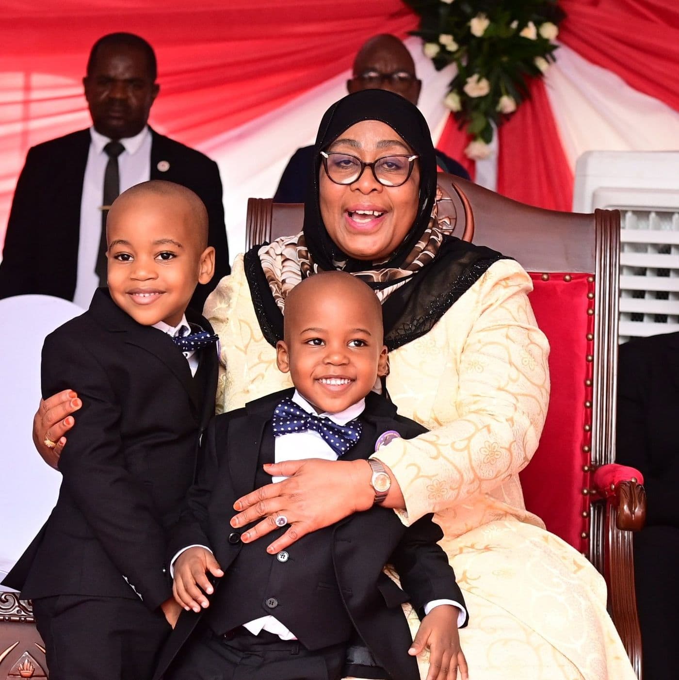 The President seated with two young boys, all three smiling